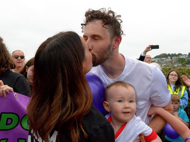 Sporting hero Danny Quigley receives a kiss from his partner Emear on his arrival at Destined after completing a gruelling 10 Ironman Triathlons in 10 days in memory of his dad and fundraising over £74,000 for charities. Photo: George Sweeney / Derry Journal. DER2135GS – 022