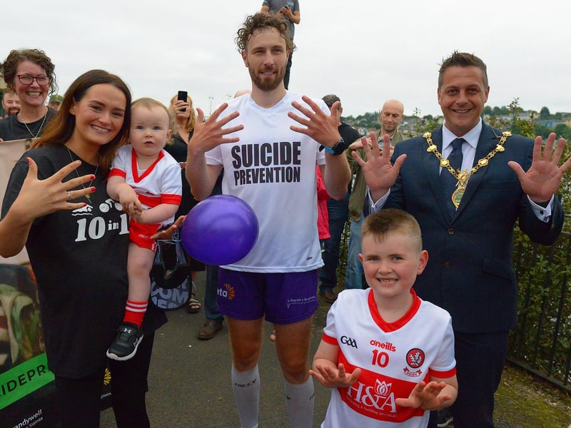 Sporting hero Danny Quigley pictured with is partner Emear, sons Jack and Malachi and the Mayor of Derry Alderman Graham Warke on his arrival at Destined after completing a gruelling 10 Ironman Triathlons in 10 days in memory of his dad and fundraising over £74,000 for charities. Photo: George Sweeney / Derry Journal. DER2135GS – 024