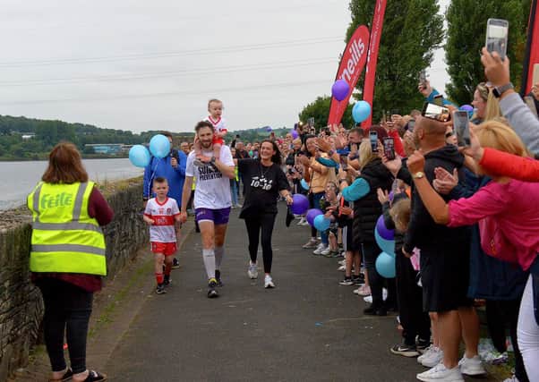 Supporters and well-wishers cheer sporting hero Danny Quigley as he finishes his epic 10 Ironman Triathlons in 10 days at Destined, Foyle Road on Sunday evening. Photo: George Sweeney / Derry Journal.  DER2135GS – 019