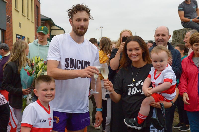 Sporting hero Danny Quigley pictured with is partner Emear and sons Jack and Malachi on his arrival at Destined after completing a gruelling 10 Ironman Triathlons in 10 days in memory of his dad and fundraising over £74,000 for charities.  Photo: George Sweeney / Derry Journal.  DER2135GS – 025