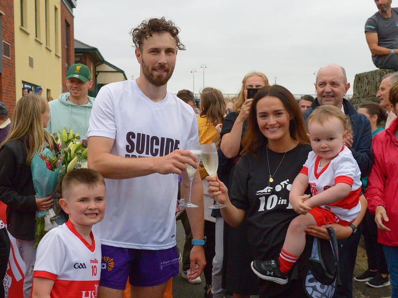 Sporting hero Danny Quigley pictured with is partner Emear and sons Jack and Malachi on his arrival at Destined after completing a gruelling 10 Ironman Triathlons in 10 days in memory of his dad and fundraising over £74,000 for charities.  Photo: George Sweeney / Derry Journal.  DER2135GS – 025