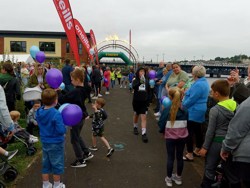 There was a carnival atmosphere as people awaited arrival of Danny Quigley at Destined, Foyle Road, after he completed a gruelling 10 Ironman Triathlons in 10 days in memory of his dad and fundraising over £74,000 for charities. Photo: George Sweeney / Derry Journal.  DER2135GS – 029
