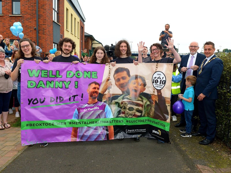 Members of Danny Quigley’s family and the Mayor of Derry and Strabane Alderman Graham Warke await his arrival at Destined after completing a gruelling 10 Ironman Triathlons in 10 days in memory of his dad and fundraising over £74,000 for charities.  Photo: George Sweeney / Derry Journal.  DER2135GS – 036
