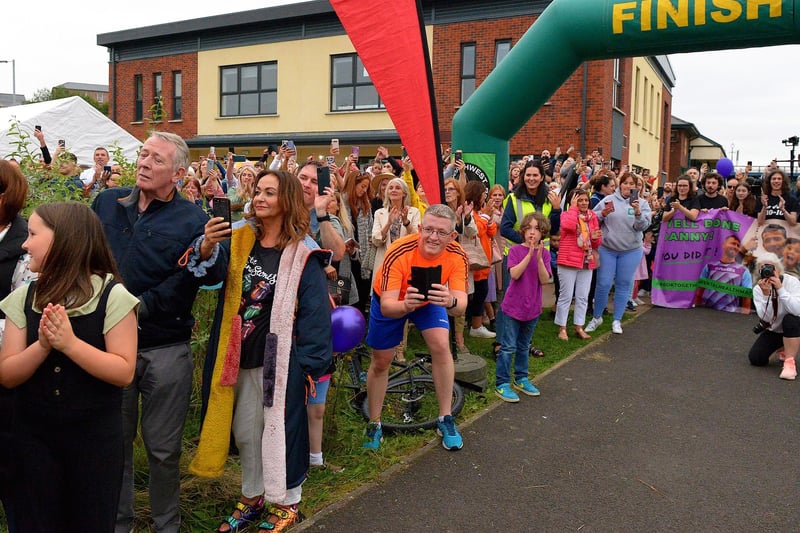 Hundreds of people turned out to greet Danny Quigley on his arrival at Destined, Foyle Road, after he completed a gruelling 10 Ironman Triathlons in 10 days in memory of his dad and fundraising over £74,000 for charities. Photo: George Sweeney / Derry Journal.  DER2135GS – 037