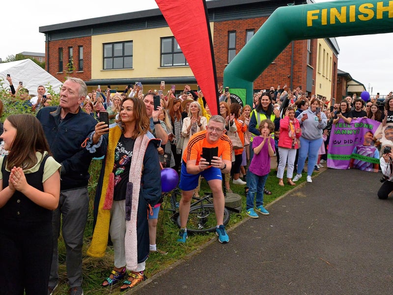 Hundreds of people turned out to greet Danny Quigley on his arrival at Destined, Foyle Road, after he completed a gruelling 10 Ironman Triathlons in 10 days in memory of his dad and fundraising over £74,000 for charities. Photo: George Sweeney / Derry Journal.  DER2135GS – 037