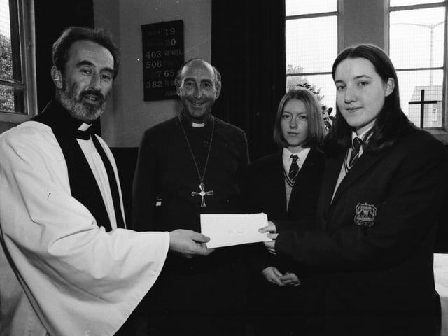 Thornhill pupils, from right, Louise Doherty and Christine McCauley, handing over a cheque of £800 to Rev. Donald McClean, whose church was damaged by fire. Included is Rev. Dr. James Mehaffey, Bishop of Derry and Raphoe.