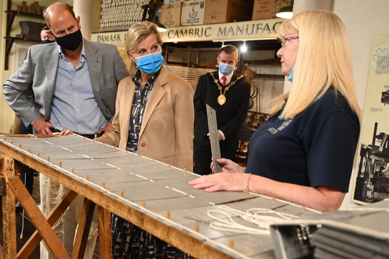 Alison explains to their Royal Highnesses how the pattern for linen is created on cards that are then placed on the loop to ensure the chosen pattern is woven.