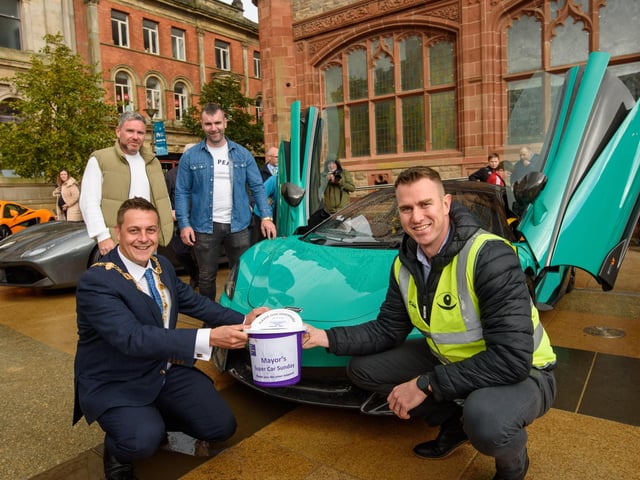 Organisers Gary McCaul and Keith Gamble with the Mayor Alderman Graham Warke and Christopher Cooper during Super Car Sunday in aid of the Mayorâ€TMs Charity Appeal for Foyle Down Syndrome Trust. Picture Martin McKeown. 03.10.21