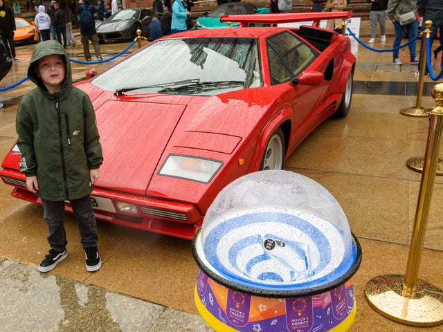 Six years old Andrew McGlinchey gets close to a Ferrari during Super Car Sunday in aid of the Mayorâ€TMs Charity Appeal for Foyle Down Syndrome Trust. Picture Martin McKeown. 03.10.21