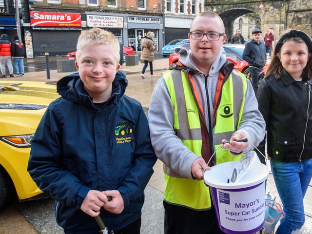 Kyle and Chloe McFaul with Declan Feeney, centre, during Super Car Sunday in aid of the Mayorâ€TMs Charity Appeal for Foyle Down Syndrome Trust. Picture Martin McKeown. 03.10.21