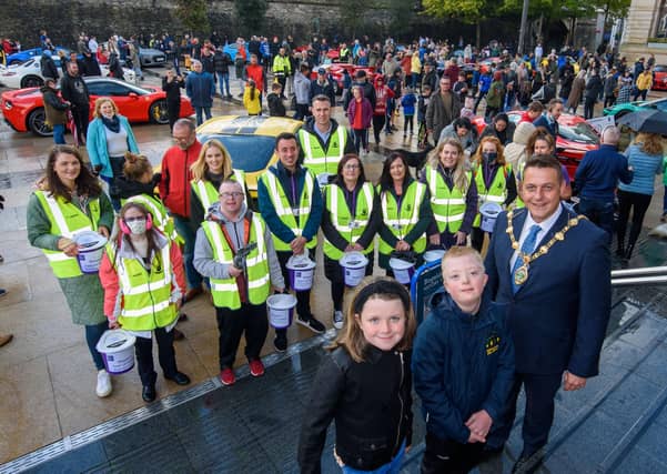 Derry City and Strabane District Council Mayor, Alderman Graham Warke pictured with staff and volunteers who helped with the collection during Super Car Sunday in aid of the Mayorâ€TMs Charity Appeal for Foyle Down Syndrome Trust. Picture Martin McKeown. 03.10.21