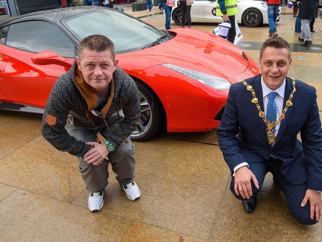 Des Adams and the Mayor get close to a Ferrari during Super Car Sunday in aid of the Mayorâ€TMs Charity Appeal for Foyle Down Syndrome Trust. Picture Martin McKeown. 03.10.21
