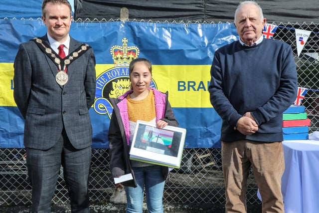 Sophie R  from Meadowbridge PS, one of the art competition winners, is pictured with Mayor Alderman Stephen Martin and Chairman of the Lisburn Royal British Legion Brian Sloan. Pic by Norman Briggs, rnbphotographyni