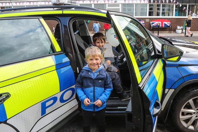 Luca and Caleb Ross trying out the police car. Pic by Norman Briggs, rnbphotographyni