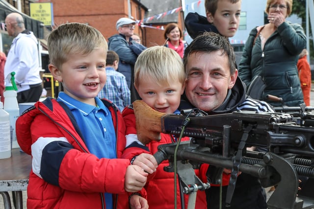 Caleb and Noah with Gary Turpie trying out the 'big guns' at the Legion street party. Pic by Norman Briggs, rnbphotographyni