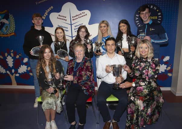 Oakgrove Integrated College Board of Governors Chair, Dr Anne Murray and Principal Katrina Crilly present prizes to Aoife, Emre,, seated. At back are Jamie, Zoe Leigh, Rebecca, Hannah Lee, Emily and Luke,