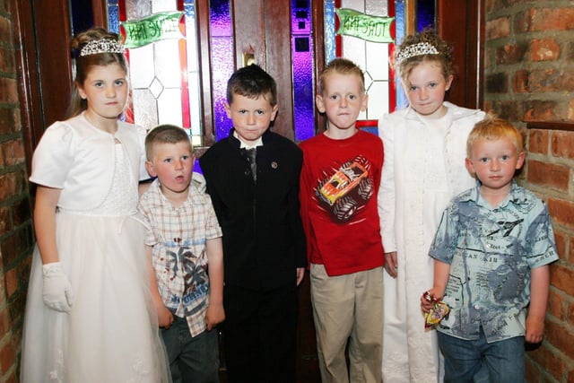 Shannon, Ryan and Terri celebrate their First Holy Communion with friends.