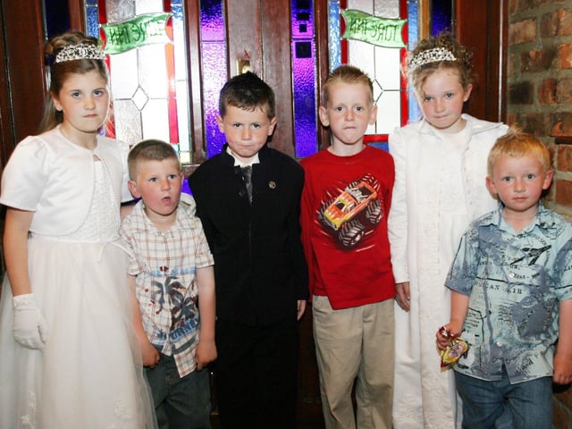 Shannon, Ryan and Terri celebrate their First Holy Communion with friends.