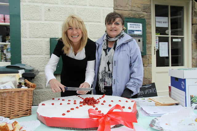 Helen Hartley of The Bakewell Pudding Parlour and Showground Manager Janet Bailey prepare to cut a giant Bakewell Tart at the first Bakewell Festival of Food in 2012