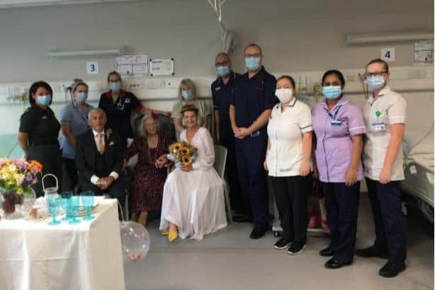 Northern General Hospital made sure Barbara Muggeridge did not miss out  on her daughter's wedding – by arranging a blessing for the wedding couple on the ward where she was being looked after so she could share in the special family moment. Pictured are the happy couple,  Anthony and Tracy O’Brien, with Tracy's mum Barbara Muggeridge and  Reverend Louise Yaull and Hunstman Five ward staff.