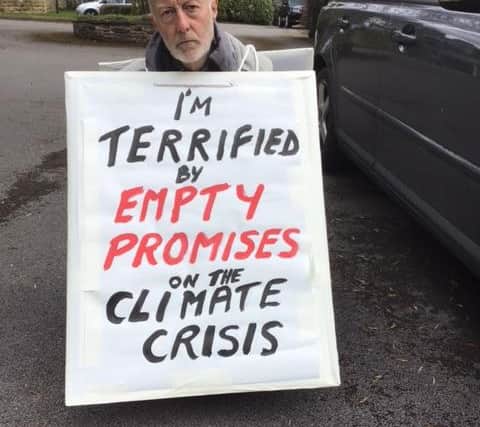 Dr Bing Jones with his sign that he will use in the protest.