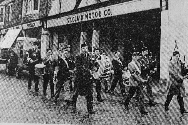 The Christian Aid Week procession was held through Kirkcaldy.
Pictured are the pipes and drums of the 4th Kirkcaldy company of the BBs parading down St Clair Street in front of a tractor loaned by the Town Council's parks department pulling a trailer loaned by car dealer Harry Brown