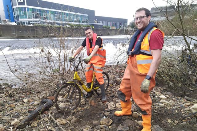Jake Hallatt (left), a Gripple moulding setter, tries out one of the bikes lifted from the river, with Sam Lake, an operational systems analyst
