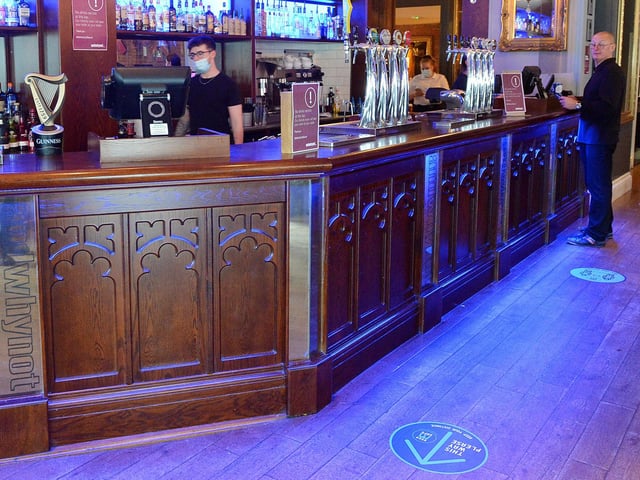 Social distancing signs on the bar floor.
