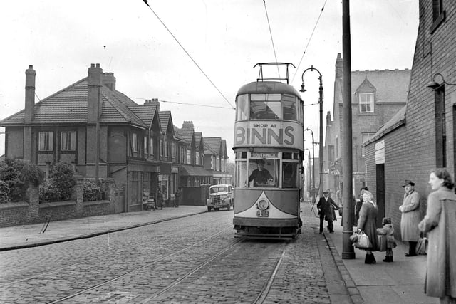 A tram passes by in this 1950s view.