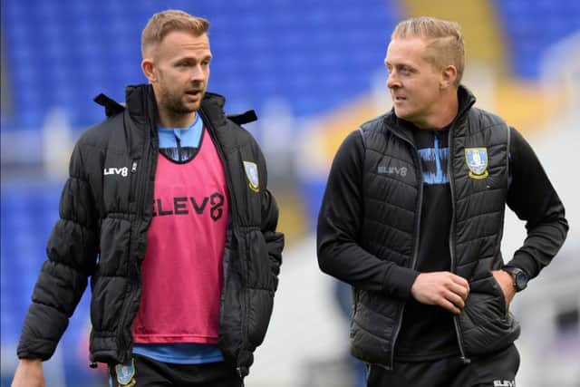 Former Sheffield Wednesday manager Garry Monk speaks with Owls forward Jordan Rhodes during his 14-month time in charge of the club.