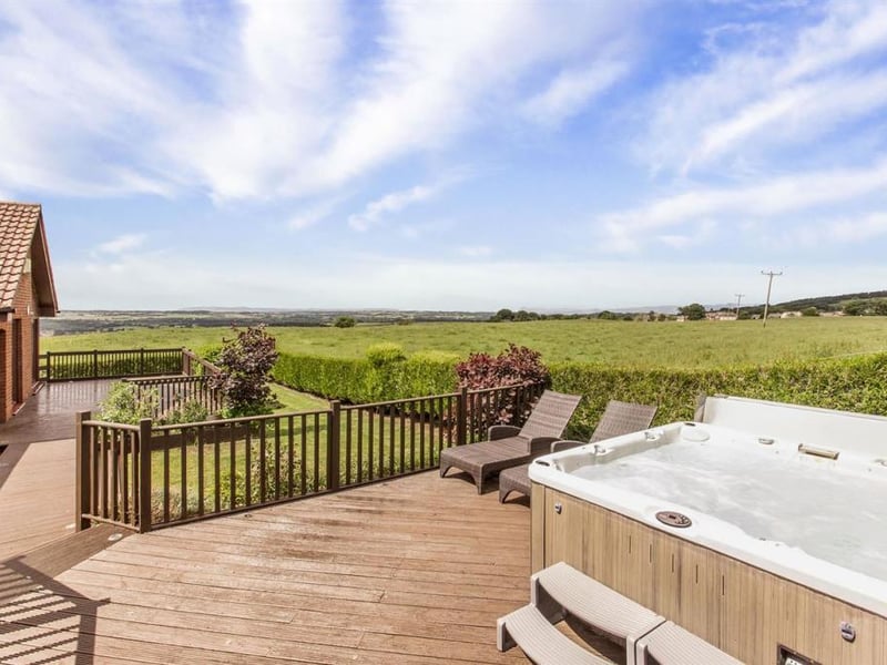 Decking area with hot tub.