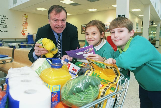 Jenna Hopkins (centre) and Connor Booth (both 9) from Athelstan Primary School, learn about maths with the supermarket shopping, with Clive Betts MP for the Big Sum Launch