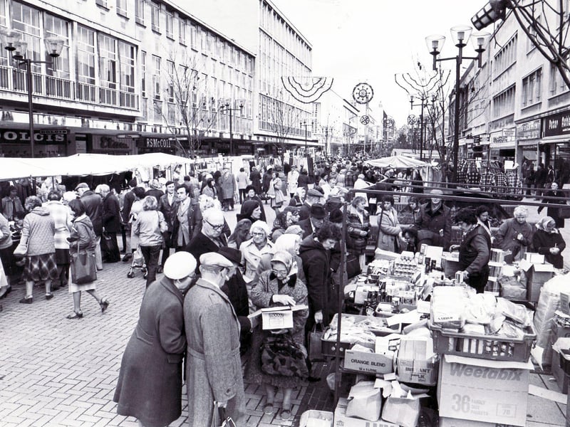 The outdoor market stalls on The Moor, Sheffield, are busy with shoppers in 1981