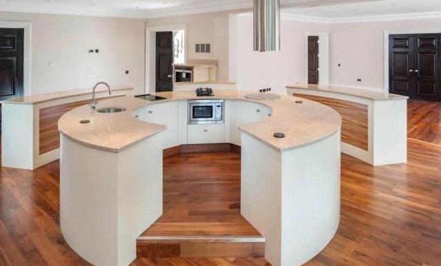 The large and luxurious kitchen includes a circular central island unit