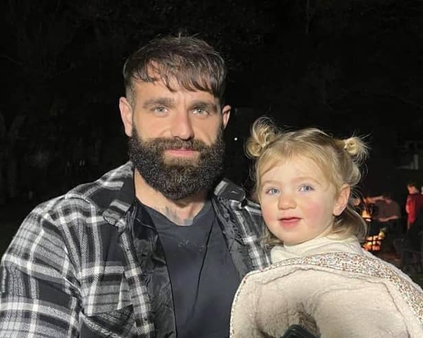 29-year-old former Hallam FC player Micah Bishop, from Handsworth, Sheffield, pictured with his daughter Bonnie on Bonfire Night this year. Credit: Jack Jeffrey