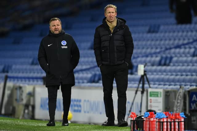 Brighton manager Graham Potter (R) and assistant coach Billy Reid look on during the Premier League match between Brighton & Hove Albion and Aston Villa at American Express Community Stadium on February 13, 2021.
