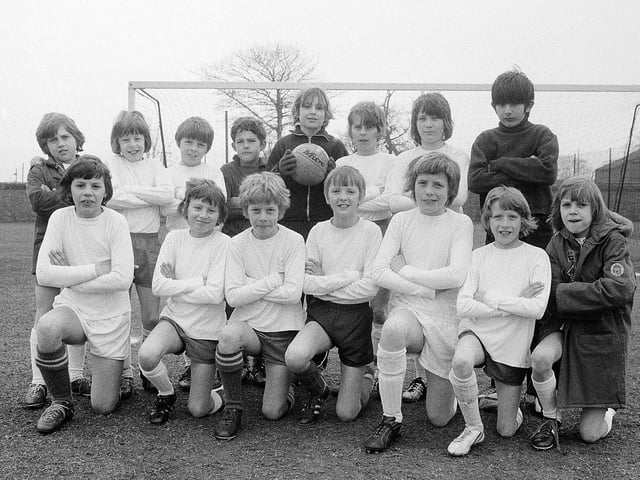 This junior football team proudly pose in their perfect white kits back in 1973. Is this you in your youth?