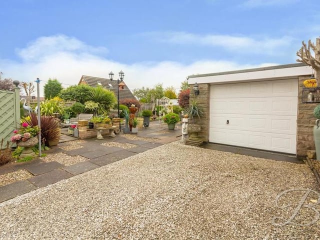 This sizeable, sturdy and stylish garage is an added bonus for potential buyers. It is at the end of a long driveway.