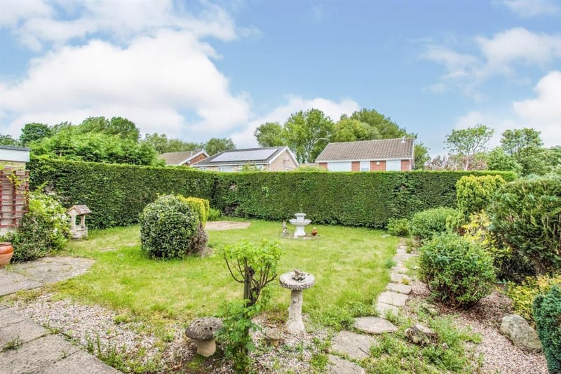The property occupies a corner plot. To the rear of the property is an enclosed lawned garden with mature shrubs and trees to the borders.