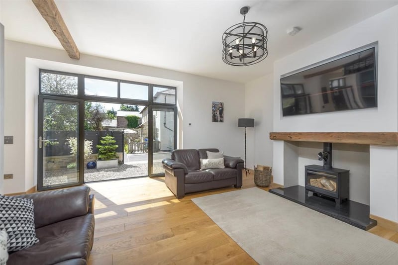 The large and spacious living area, benefiting from an abundance of natural light from the sliding doors providing access into the front garden.