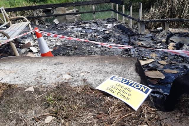 Firefighters say a massive blaze in Manor Fields Park, near City Road, Sheffield, which could be seen from miles away, was arson. PIctured is the charred remains of a decked and seating area.