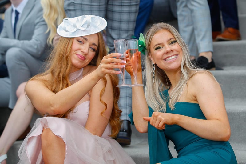 Two women looking elegant whilst enjoying a glass of fizz on their day out.