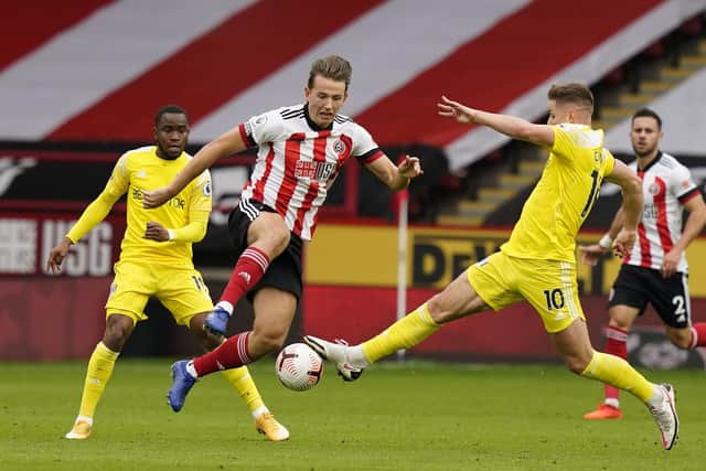Sander Berge of Sheffield Utd (C) wins the ball from Tom Cairney of Fulham during the Premier League match at Bramall Lane, Sheffield.   Andrew Yates/Sportimage