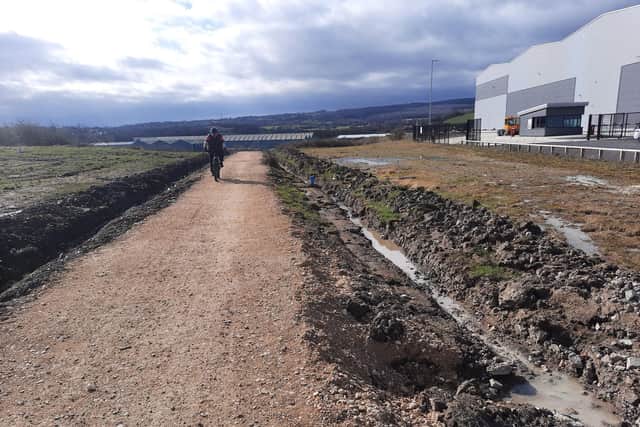 Part of the route through Smithywood Business Park in Chapeltown has been surfaced with sand and stones and rolled, with drainage channels cut either side.