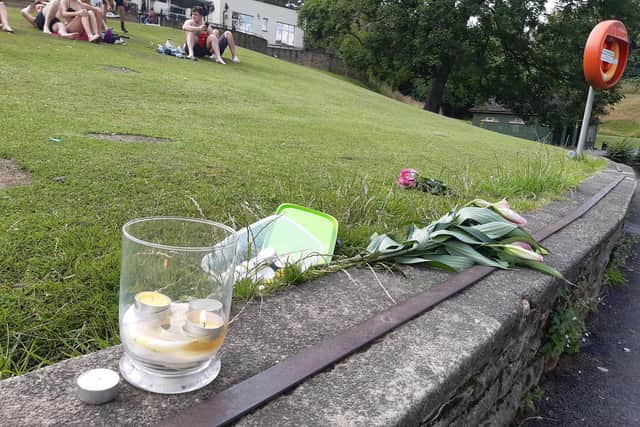 Candles in tribute to the man who died in Crookes Valley Lake by the side of the water