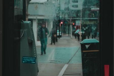 A view of the town centre through the glass of a phone box.