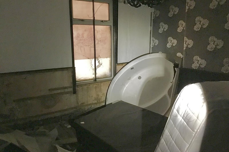 PIcture shows inside one of the rooms at the former City Sauna, including a mattress and a bath tub