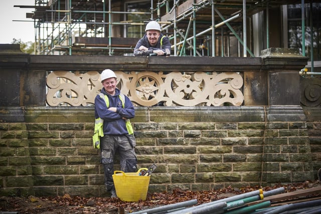 Stonemason Stephen Spence and his colleague Tom Wilson working on the wall around the house