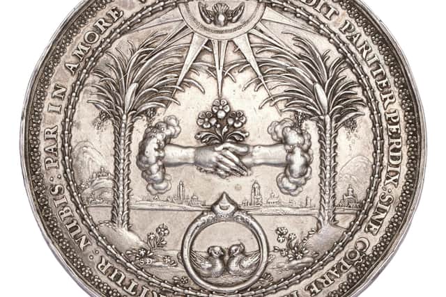 The reverse side of the intricately embellished medal.