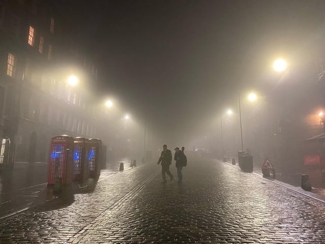 Two people making their way across Edinburgh's iconic Royal Mile as the city took up the spooky mantle of a horror film scene last night.